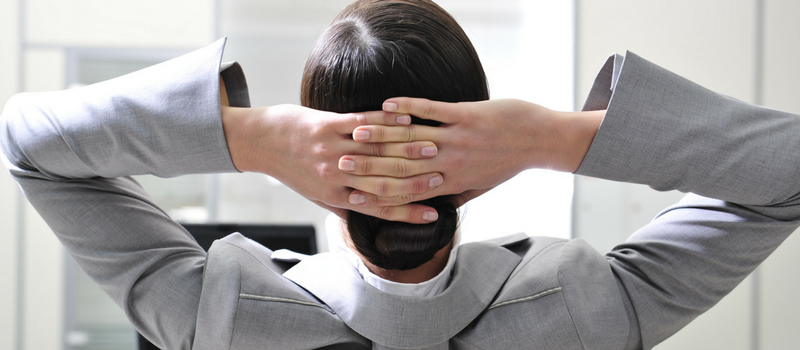 a man with his arms crossed behind his head facing the other direction