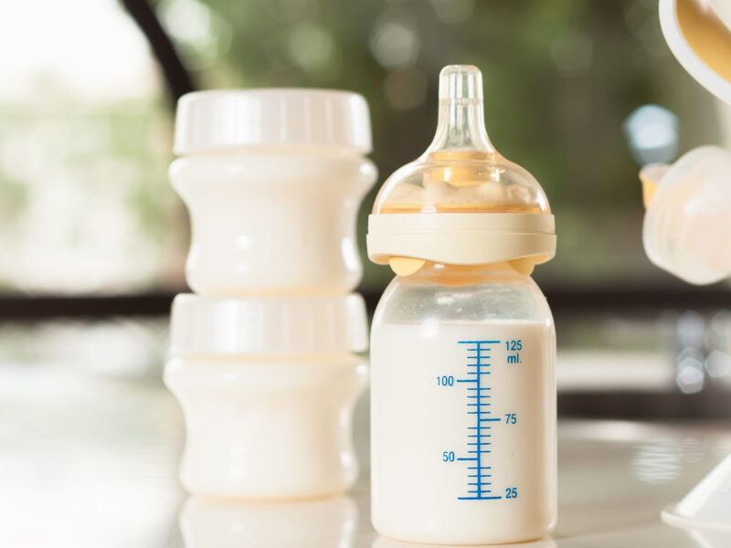 Baby bottle with milk and manual breast pump