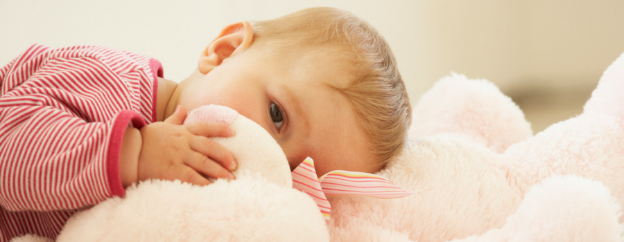 a baby laying on a stuffed animal