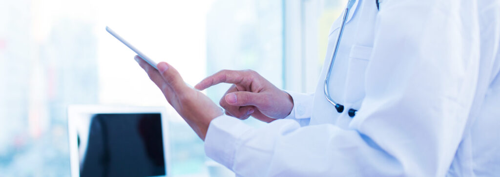 Cropped shot of a male doctor using a digital tablet