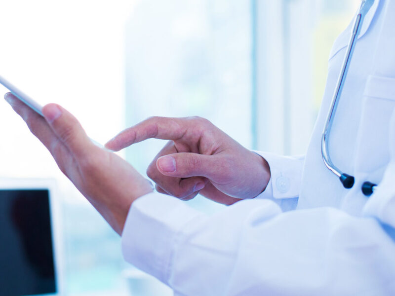 Cropped shot of a male doctor using a digital tablet