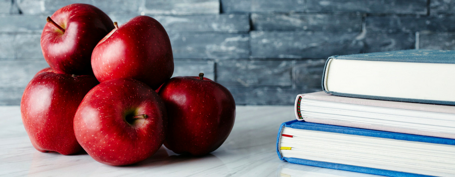 apples stacked next to books