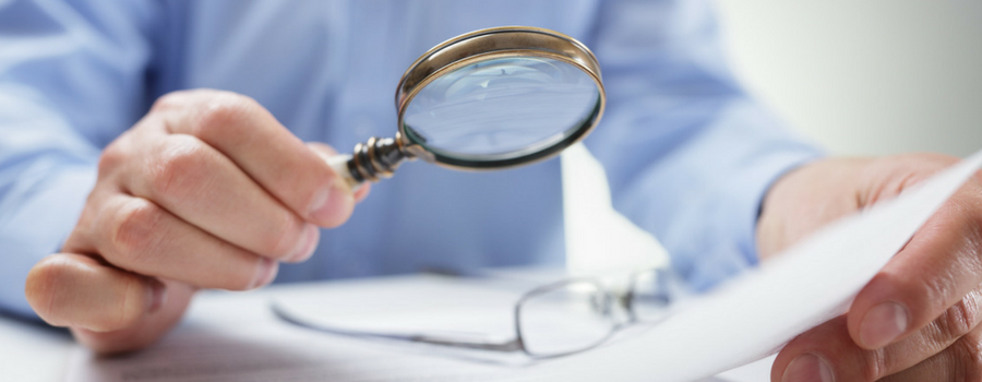 a hand holding a magnifying glass