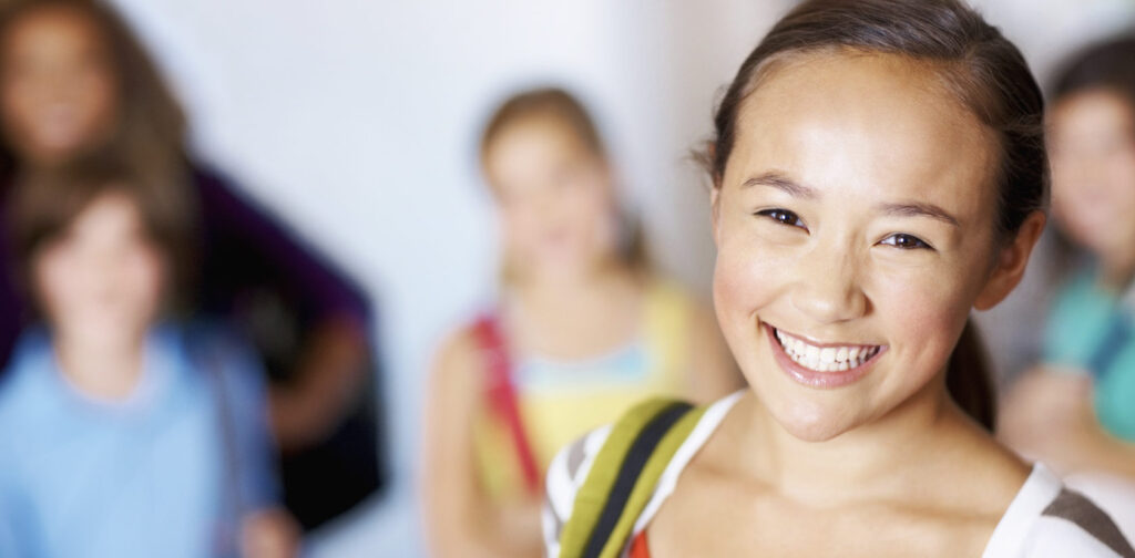 a young girl smiling