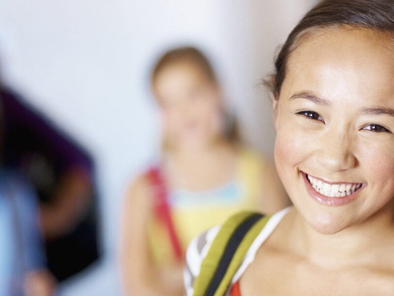 a young girl smiling