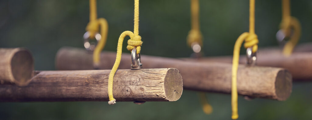 a row of logs hanging by yellow string