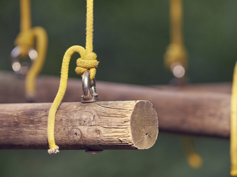 a row of logs hanging by yellow string